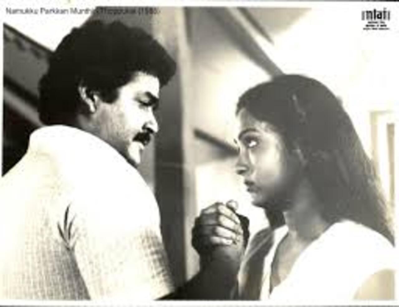 Namukku Parkkan Munthiri Thoppukal
Starring Mohanlal, this Malayalam rom-com was way ahead of its time and released in 1986. The romantic drama directed by P. Padmarajan continues to attract the audience for its poignant storytelling. It revolves around Solomon (Mohanlal), a young Christian man from a conservative family, and Sofia (Shari), a Hindu woman, falling in love amid all odds. It is available on Amazon Prime Video. 